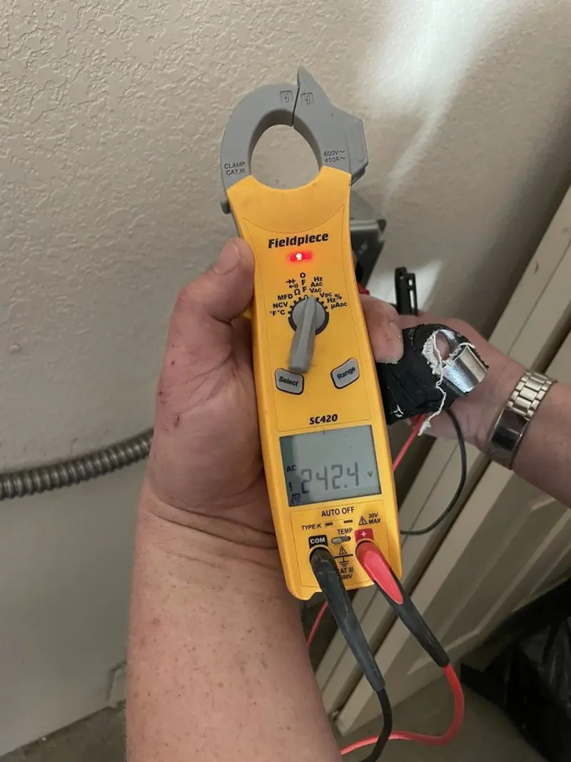 Voltage testing with clamp meter during Electrical Installation Services in Tipton